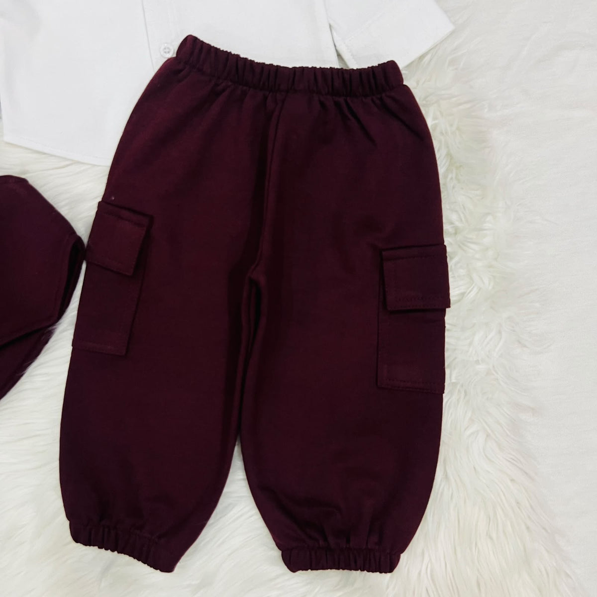 The ultimate 3-piece formal set: crisp white collared shirt, burgundy vest, and matching cargo trousers