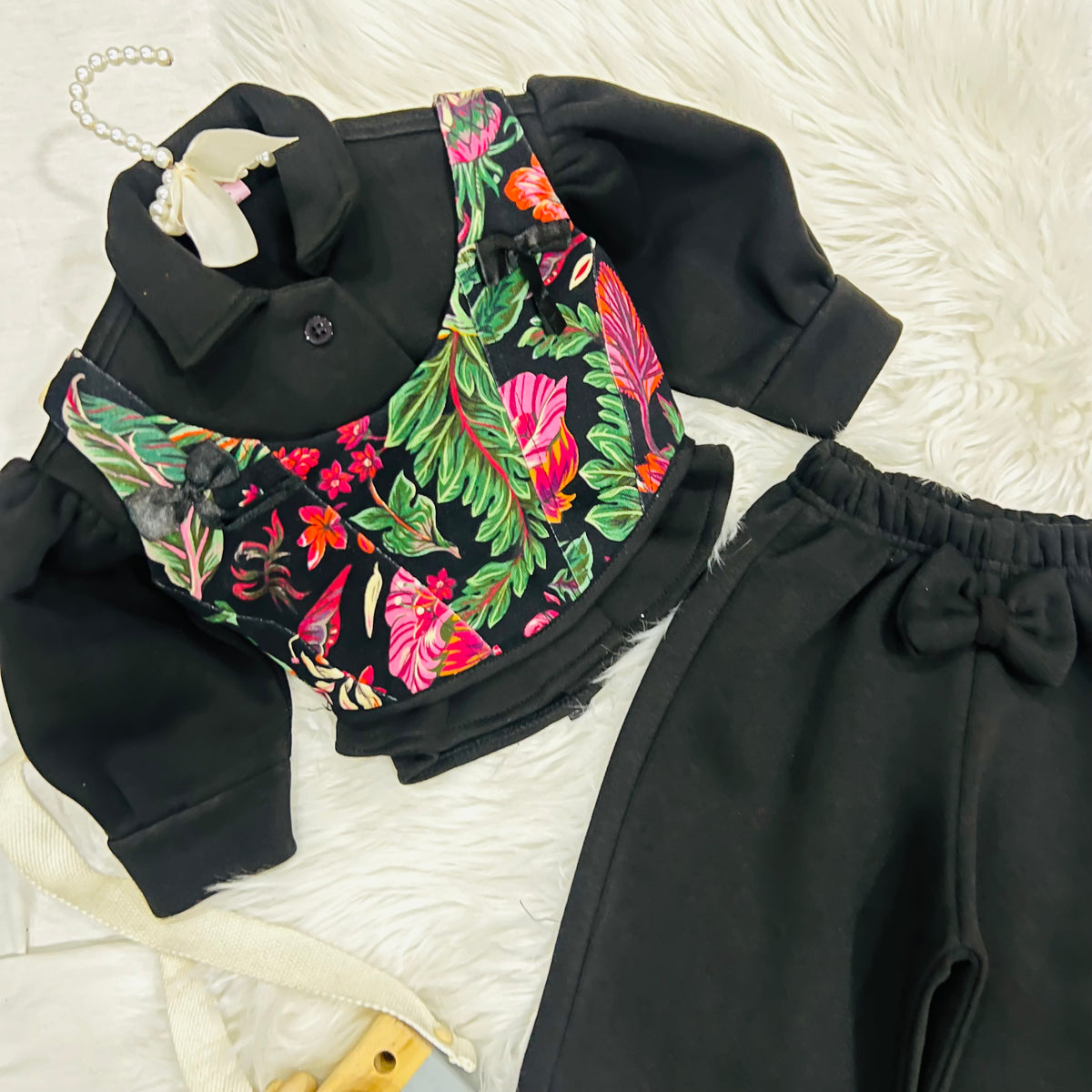 Effortless style meets vibrant tropical prints. Featuring a black long-sleeve top paired with a floral corset-style overlay, wide-leg trousers winter fleece stuff (Copy)