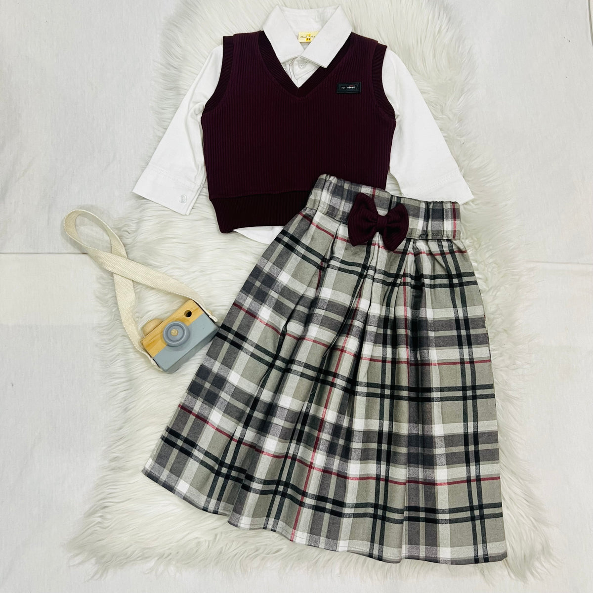 The ultimate 3-piece formal set: crisp white collared shirt, burgundy sweater and matching  long   Check skirt fleece stuff