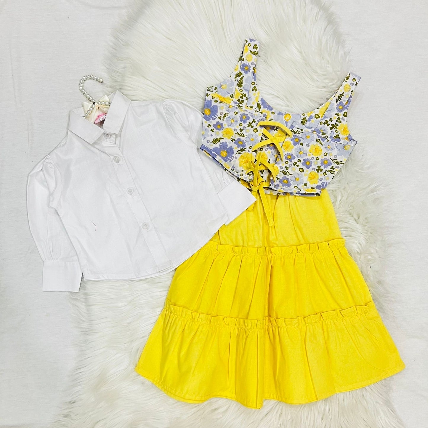 White Puff-sleeve Button-up Blouse Layered With White Floral Print Corest Top Paired With Vibrant Yellow Tiered Ruffle Skirt