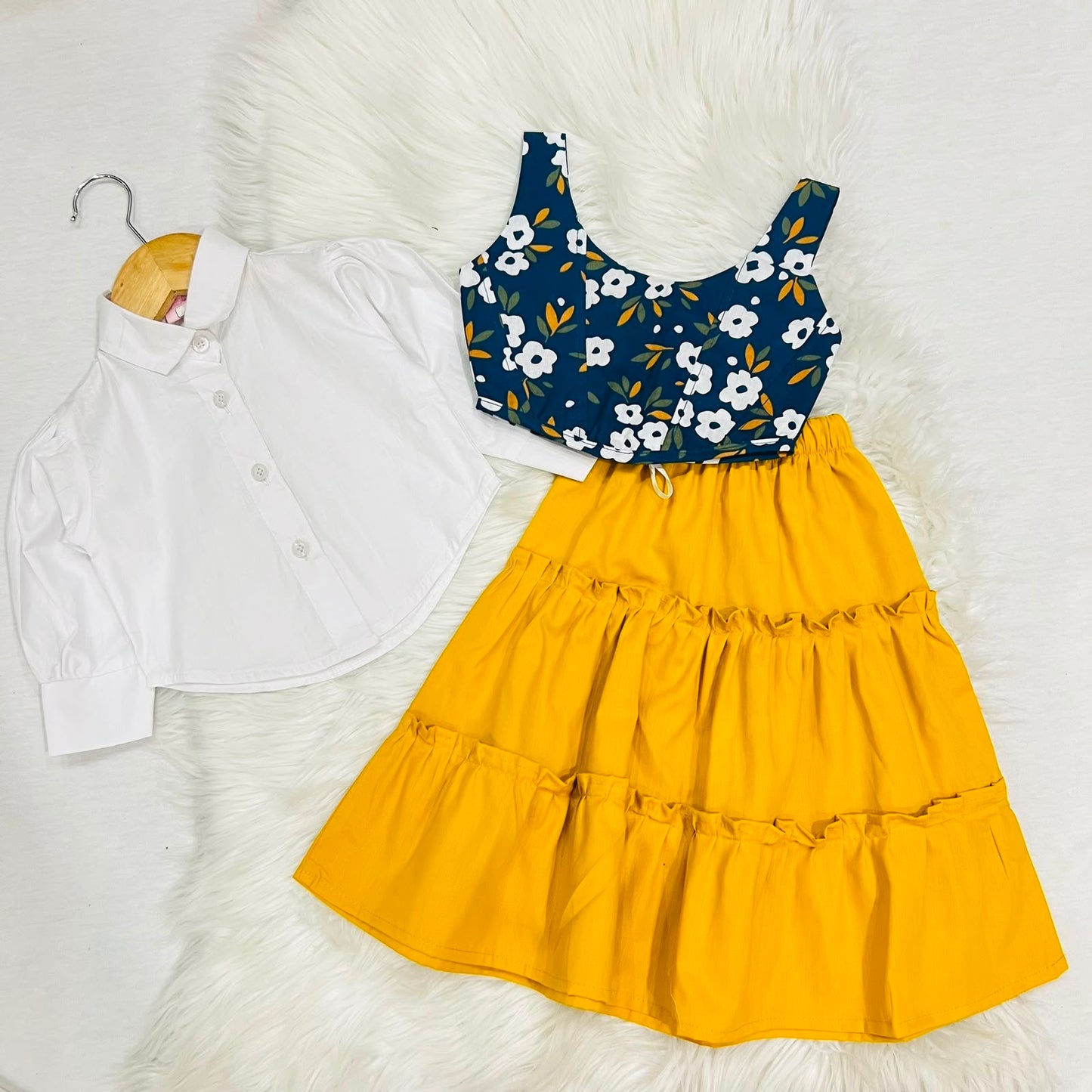 White Puff-sleeve Button-up Blouse Layered With Navy Blue Floral Print Corest Top Paired With Vibrant Yellow Tiered Ruffle Skirt
