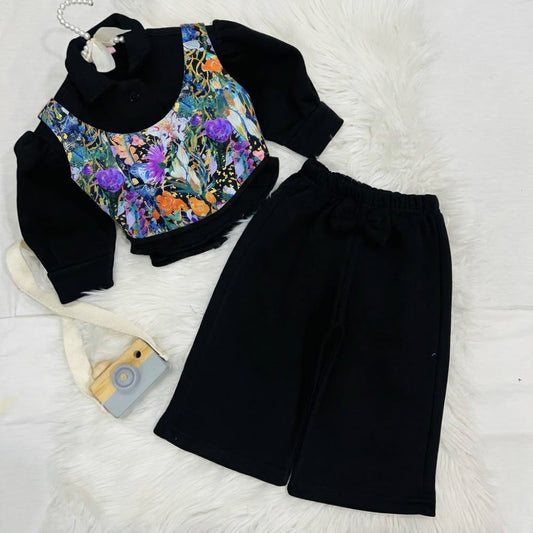 Effortless style meets vibrant tropical prints. Featuring a black  long-sleeve top paired with a floral corset-style overlay, wide-leg trousers winter fleece stuff