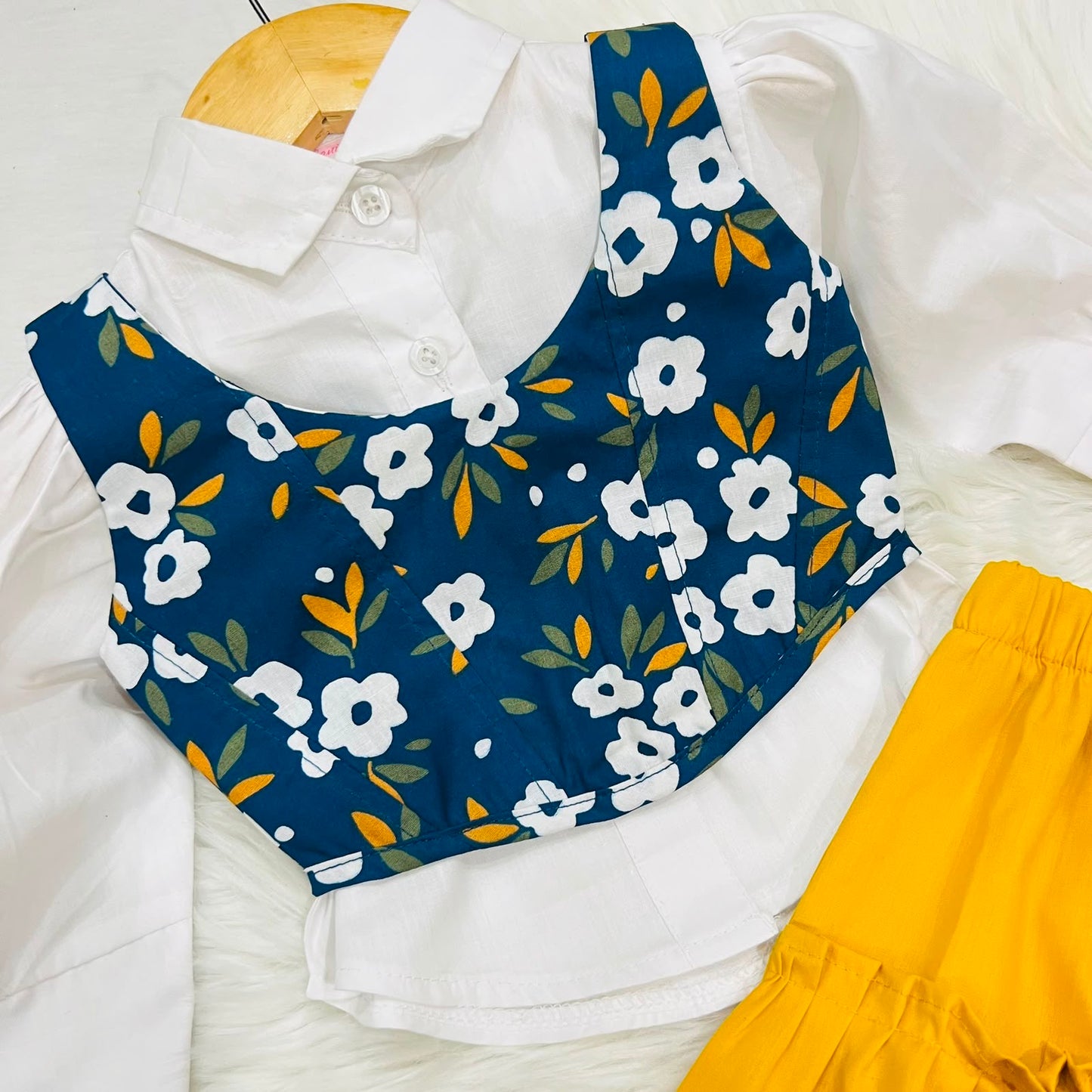 White Puff-sleeve Button-up Blouse Layered With Navy Blue Floral Print Corest Top Paired With Vibrant Yellow Tiered Ruffle Skirt