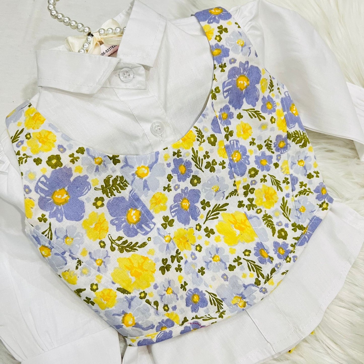 White Puff-sleeve Button-up Blouse Layered With White Floral Print Corest Top Paired With Vibrant Yellow Tiered Ruffle Skirt