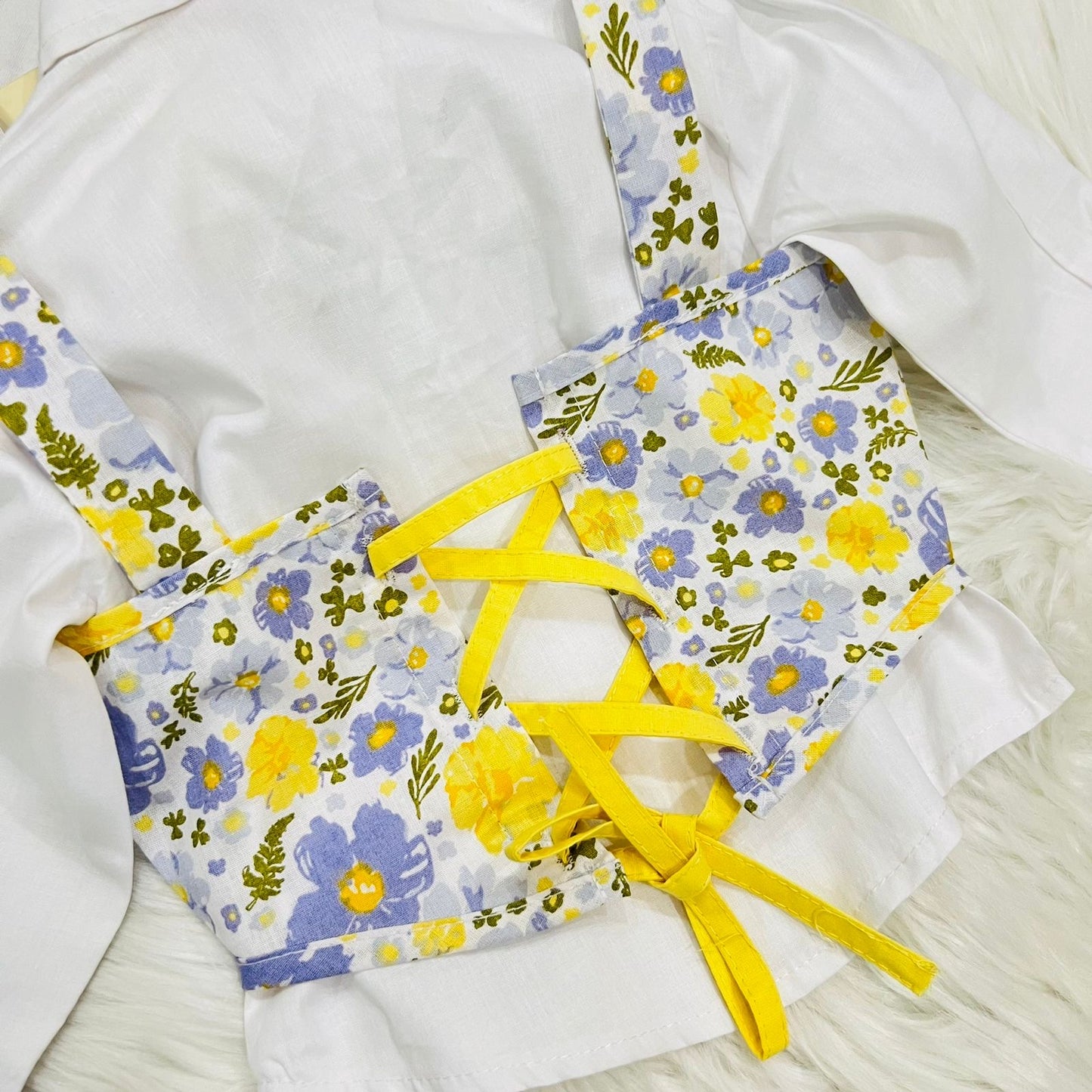 White Puff-sleeve Button-up Blouse Layered With White Floral Print Corest Top Paired With Vibrant Yellow Tiered Ruffle Skirt