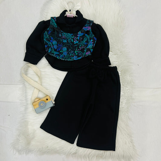 Effortless style meets vibrant tropical prints. Featuring a black long-sleeve top paired with a floral corset-style overlay, wide-leg trousers winter fleece stuff