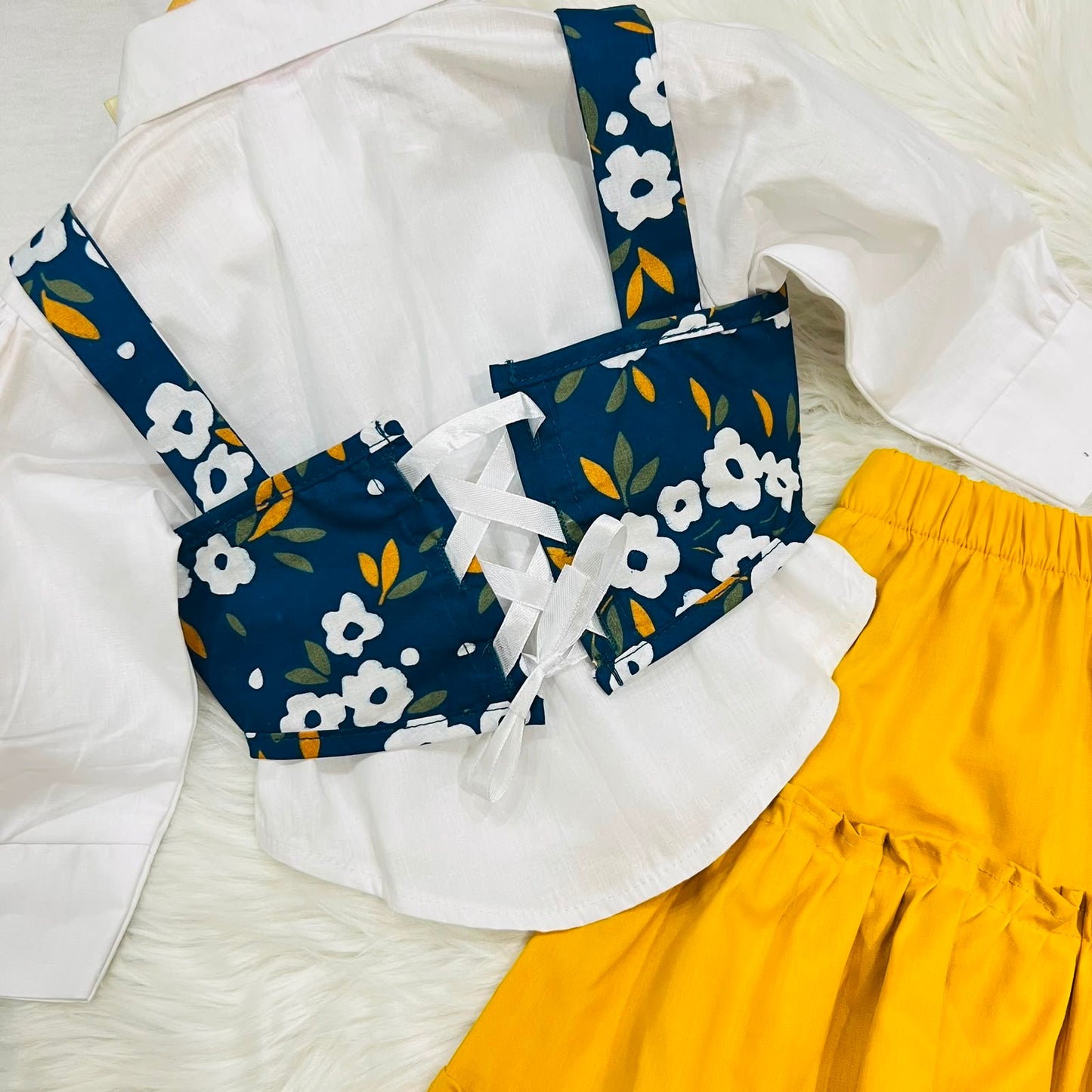 White Puff-sleeve Button-up Blouse Layered With Navy Blue Floral Print Corest Top Paired With Vibrant Yellow Tiered Ruffle Skirt