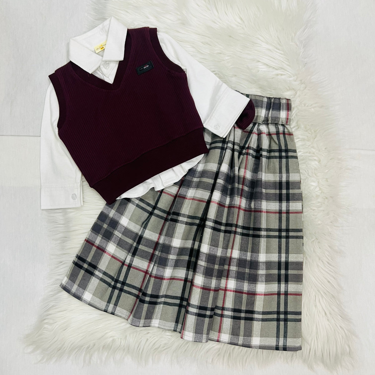 The ultimate 3-piece formal set: crisp white collared shirt, burgundy sweater and matching  long   Check skirt fleece stuff