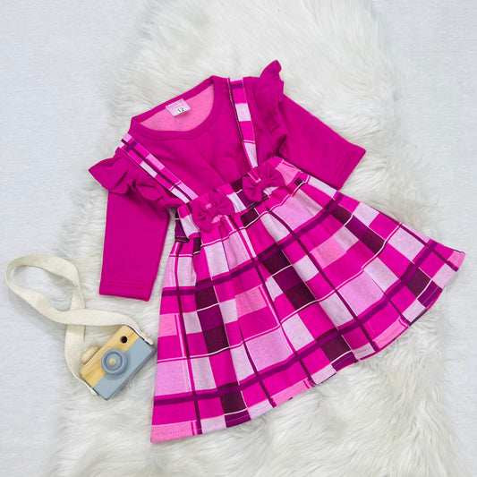 A bright pink long-sleeve top paired with a matching pink and magenta plaid suspender skirt fleece