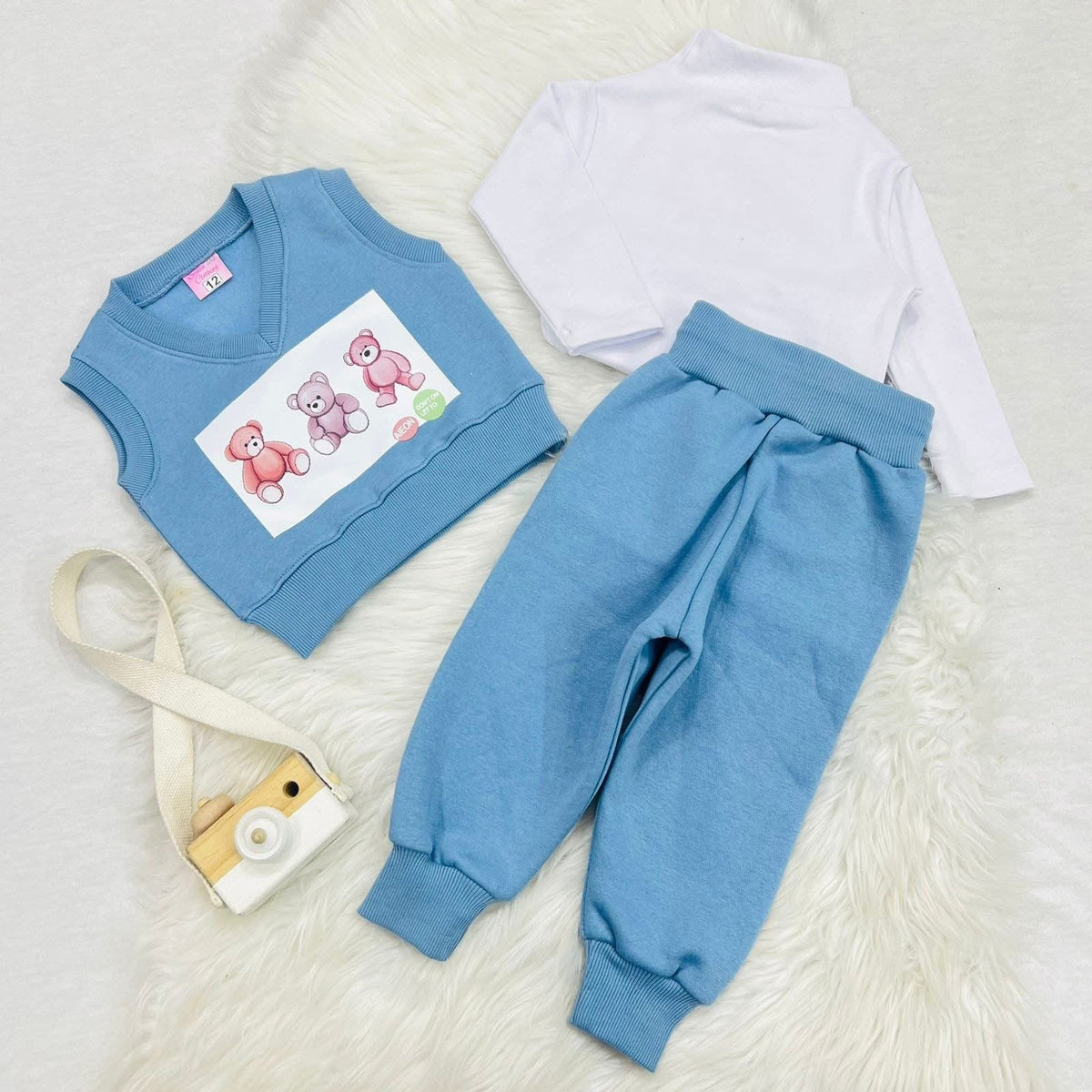 Piece baby and toddler outfit set featuring a light blue knitted bear vest, a white long-sleeve top, and matching blue trousers. Fleece stuff