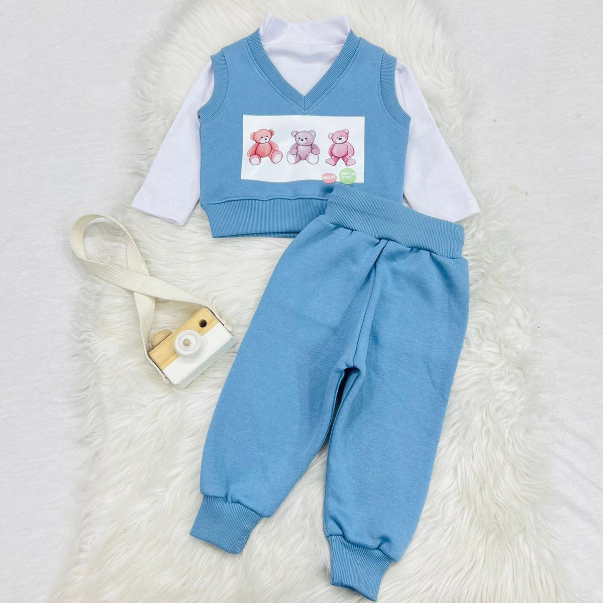 Piece baby and toddler outfit set featuring a light blue knitted bear vest, a white long-sleeve top, and matching blue trousers. Fleece stuff