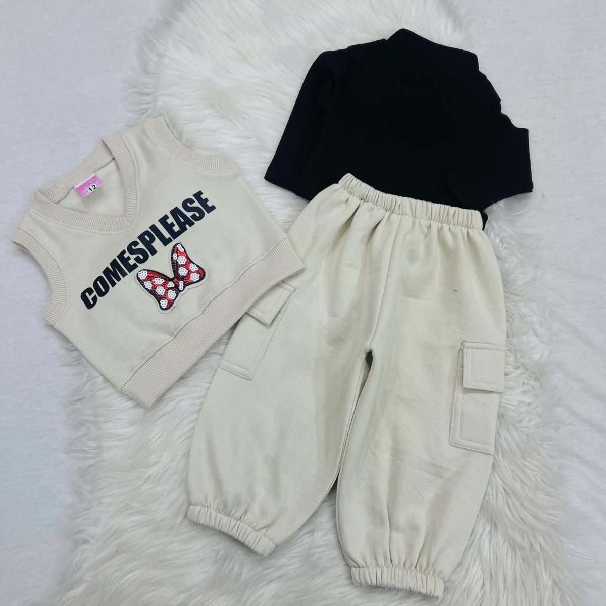 Three-piece children's clothing set with a black long-sleeve top, a cream-colored knit vest, and matching cream-colored cargo jogger pants. Fleece stuff