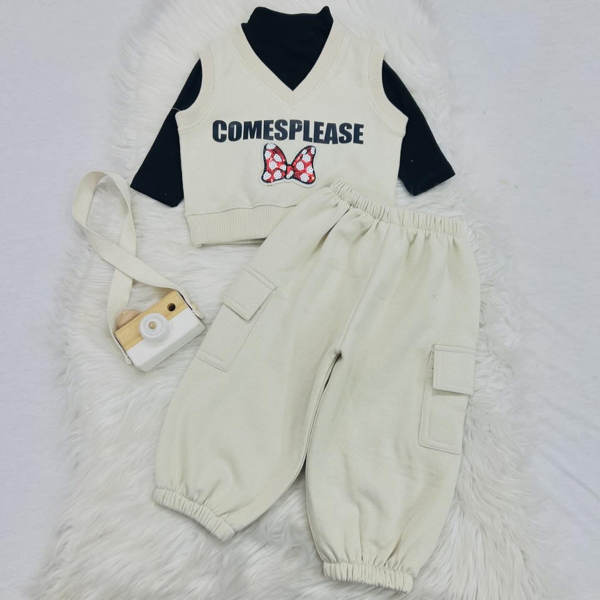 Three-piece children's clothing set with a black long-sleeve top, a cream-colored knit vest, and matching cream-colored cargo jogger pants. Fleece stuff