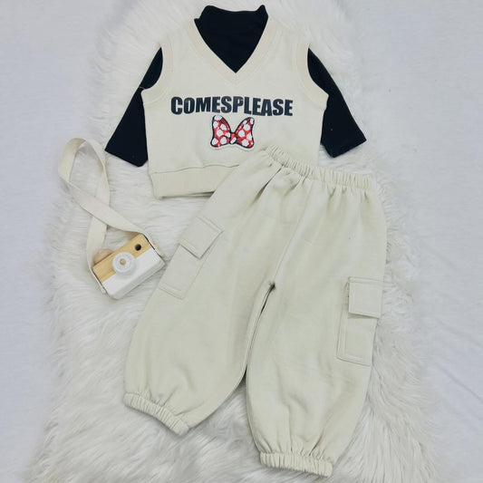 Three-piece children's clothing set with a black long-sleeve top, a cream-colored knit vest, and matching cream-colored cargo jogger pants. Fleece stuff