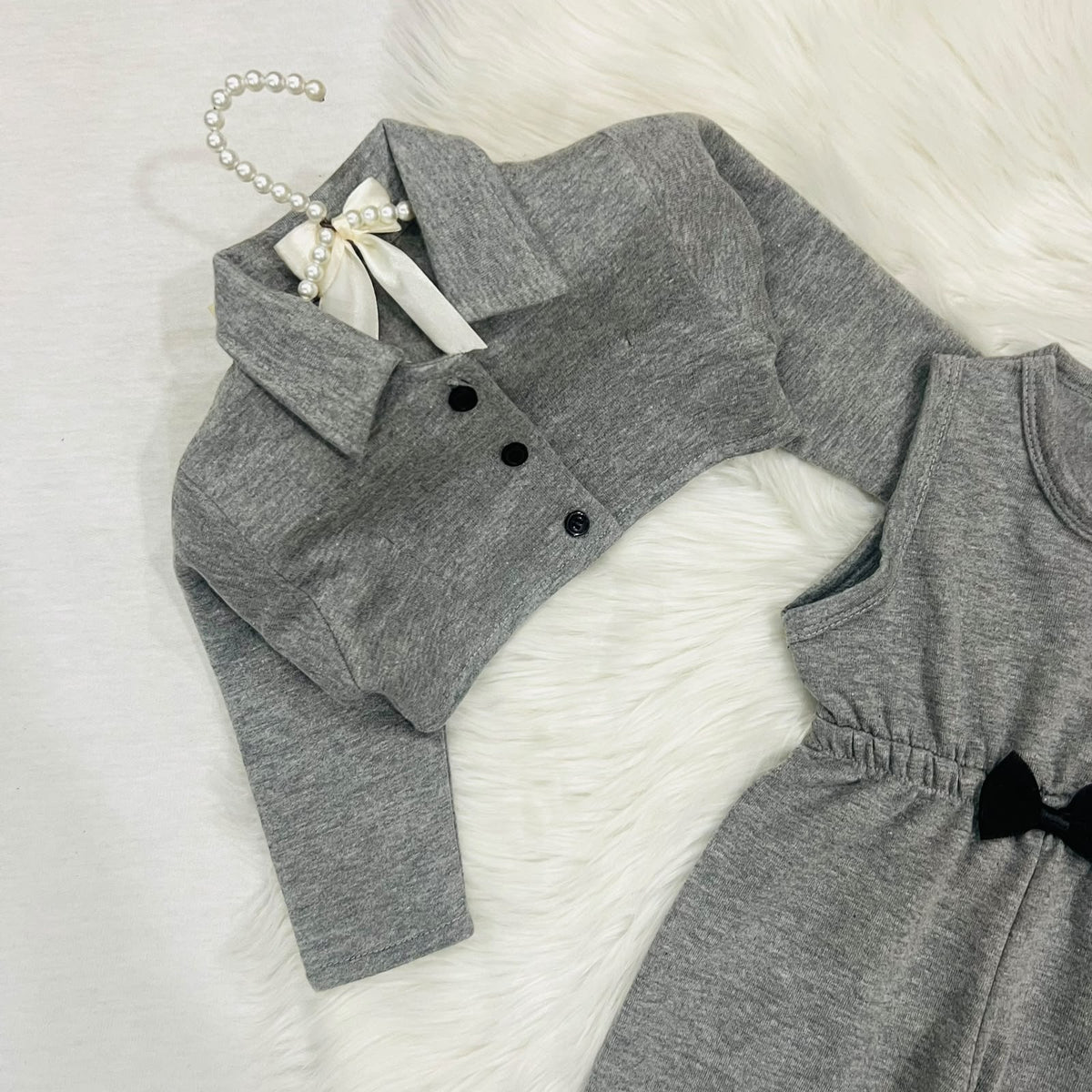 Gray two-piece baby girl outfit featuring a sleeveless romper with a black bow and a matching long-sleeve button-down jacket fleece winter stuff
