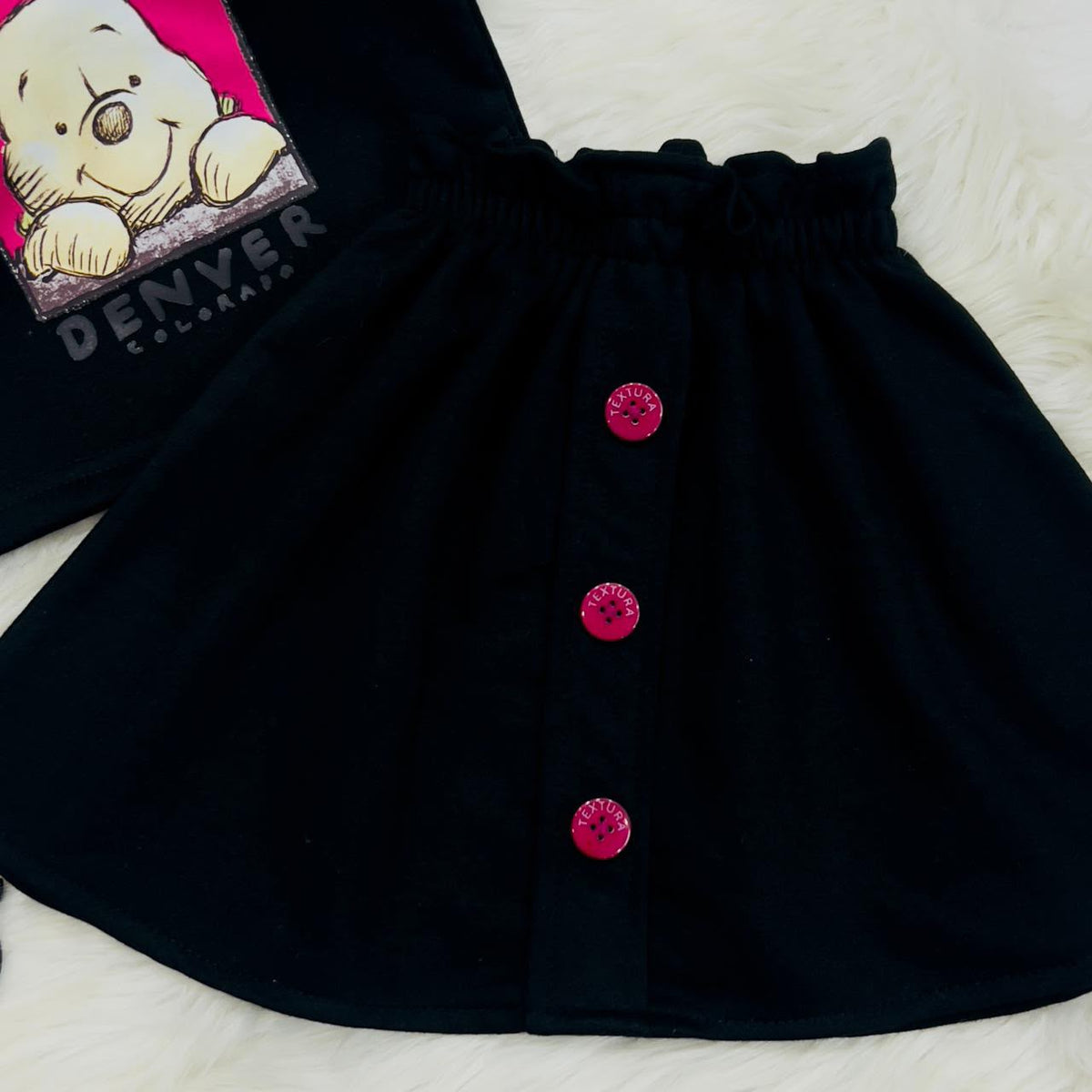 A ruffled-shoulder graphic sweatshirt paired with an A-line skirt with pink accent buttons 2000 2200 fleece winter stuff